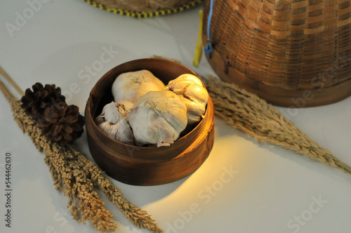 garlic on basket from bamboo with light blur background