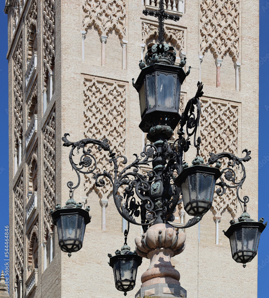 Street lamp with Tower of the Cathedral in Sevilla in the background