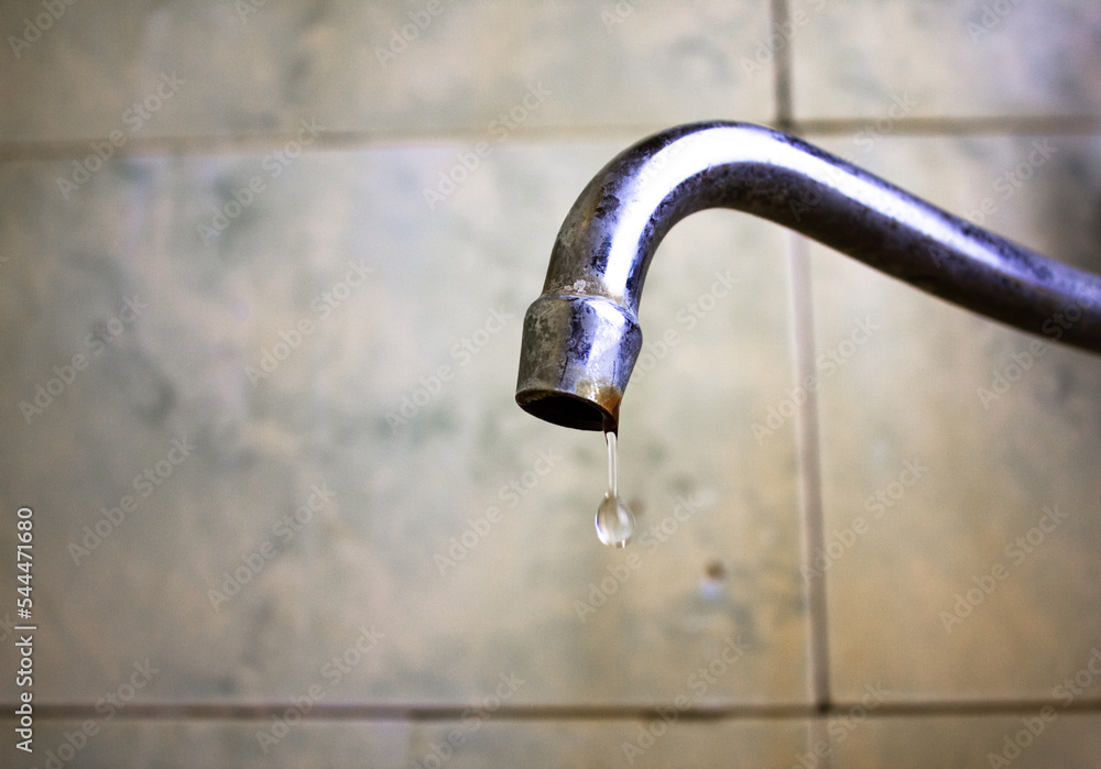 Old dirty faucet in the bathroom.Old water faucet.Drips from an old rusty faucet. Old dirty faucet in the bathroom.Old water faucet.Drips from an old rusty faucet.