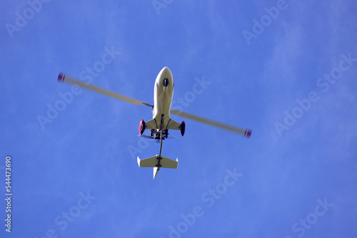 Gyrocopter flying with background of blue sky photo