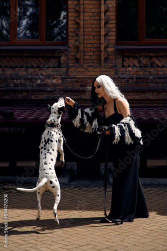 Cosplay on Cruella de Vil with a Dalmatian