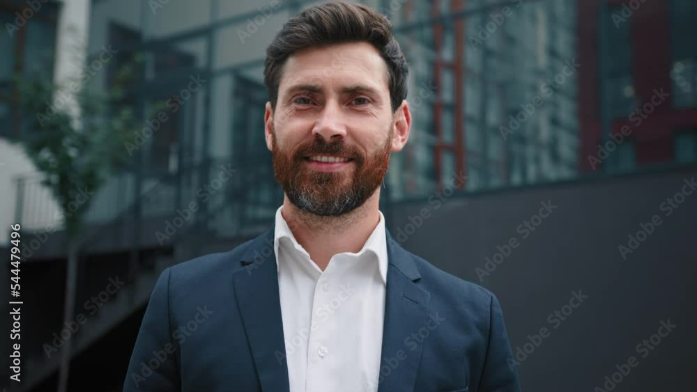 Handsome man caucasian bearded 40s businessman leader boss successful male business owner happy adult millennial guy stand in city outside modern office company posing looking at camera joyful smiling Handsome man caucasian bearded 40s businessman leader boss successful male business owner happy adult millennial guy stand in city outside modern office company posing looking at camera joyful smiling