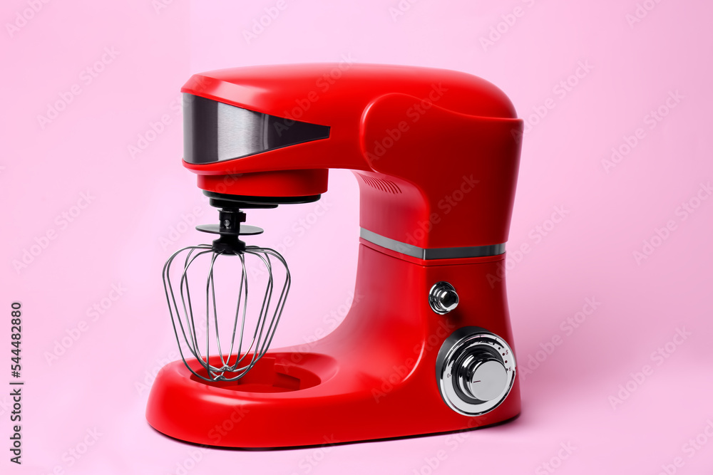 Modern red stand mixer on pink background Modern red stand mixer on pink background