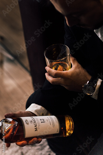 person with a bottle of whisky