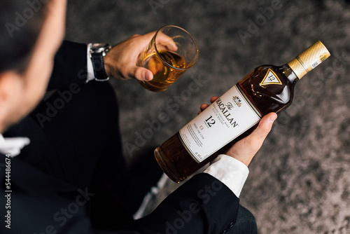 person with a bottle of whisky