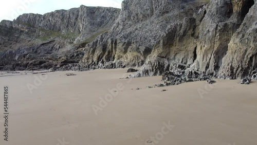 Sandy Beach with Jagged Rocks with Small Sea Caves - Aerial Drone Shot 4K photo