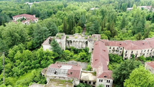 Massive derelict Sanatorium building in Georgia, aerial fly toward view photo