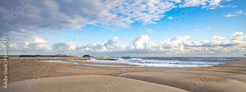 Geotextile bags filled with sand laid in formation for erosion protection for the Cotton Tree beach coastline at the Maroochy River mouth,  a popular tourist family destination.  photo