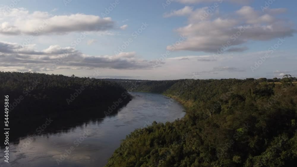 Iguazu River flowing in Amazon basin at border between Brazil and Argentina. Aerial drone rising Iguazu River flowing in Amazon basin at border between Brazil and Argentina. Aerial drone rising