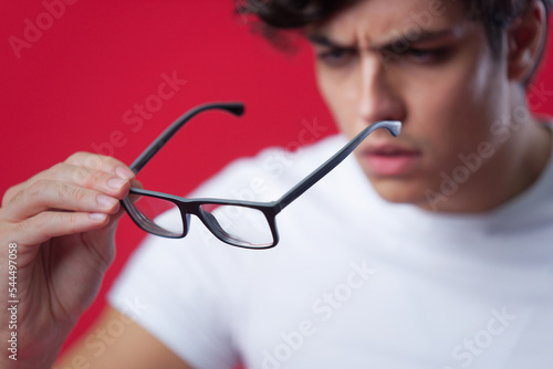 Photos Checking his glasses, shortsighted man examining his spectacles, blurred person