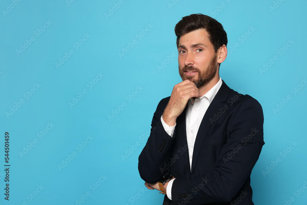 Portrait of handsome bearded man in suit on light blue background. Space for text Portrait of handsome bearded man in suit on light blue background. Space for text
