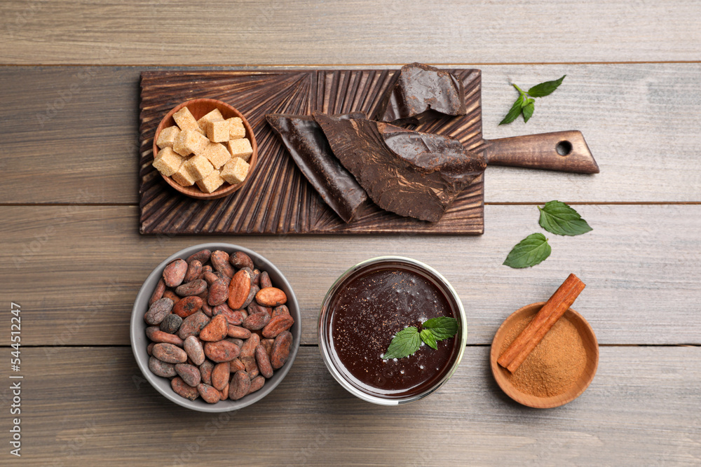 Flat lay composition with glass of hot chocolate on wooden table