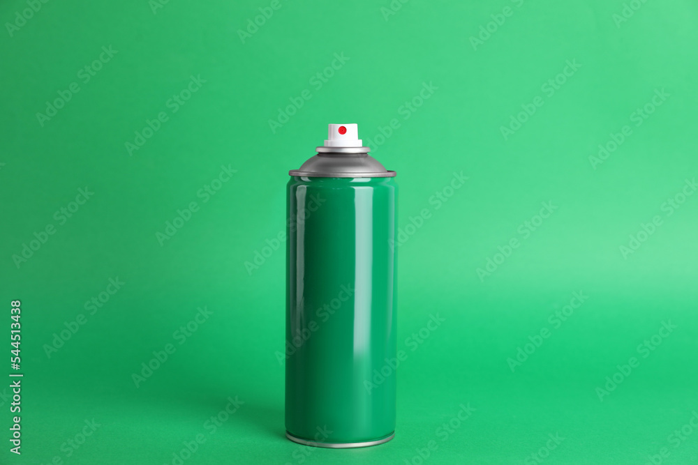 Colorful can of spray paint on green background Colorful can of spray paint on green background