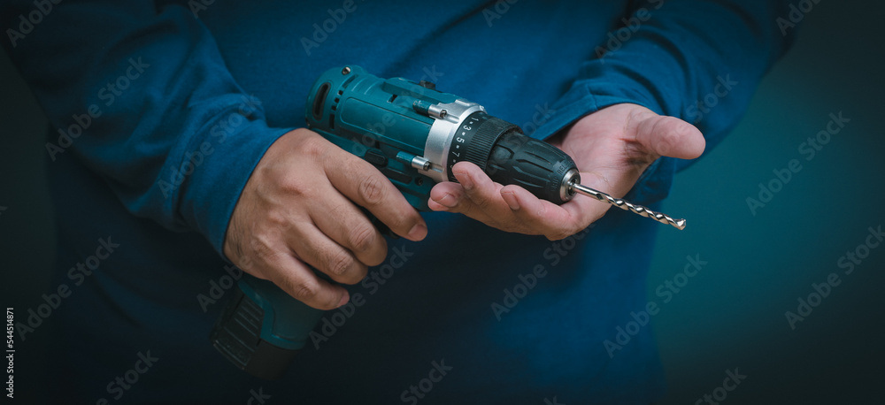 close-up hand holding an electric drill close-up hand holding an electric drill