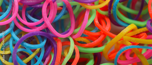 Many colorful rubber bands, closeup view © Pixel-Shot