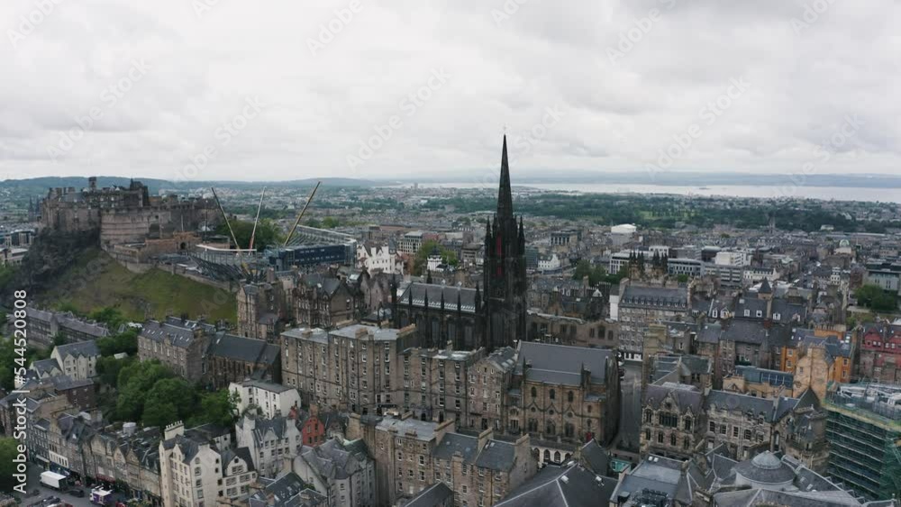 The Hub tower and Edinburgh Castle on hill in the morning. Aerial orbit cityscape of old town. The Hub tower and Edinburgh Castle on hill in the morning. Aerial orbit cityscape of old town.