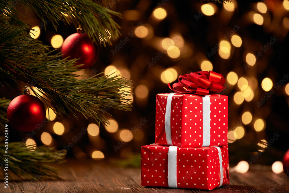red boxes with gifts on a festive Christmas background.