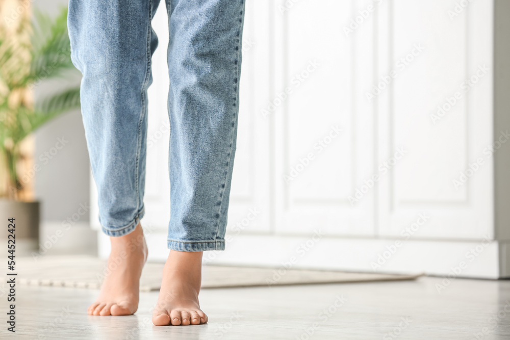 Barefoot legs of woman walking on floor at home Barefoot legs of woman walking on floor at home