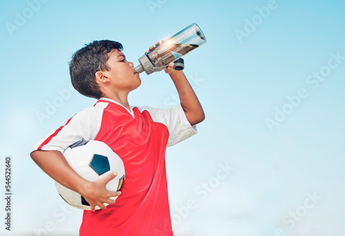 Murais de parede Training, sports and football with child drinking water for fitness, health or endurance exercise