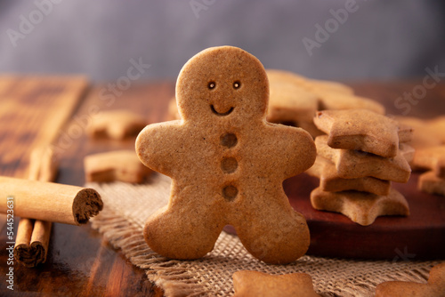 Homemade smiling gingerbread man cookie, traditionally made at Christmas and the holidays. Closeup.