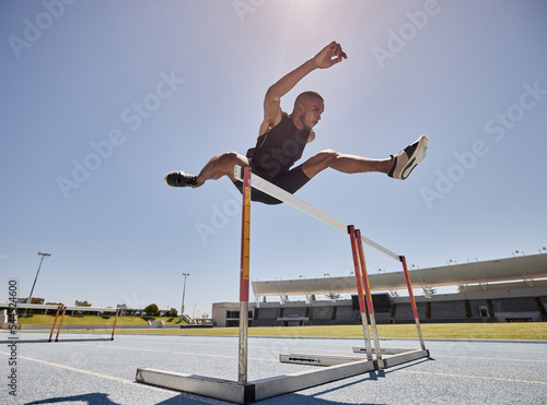 Bild auf Leinwand Running, jump and athlete hurdle for a speed exercise, marathon or runner training in a stadium