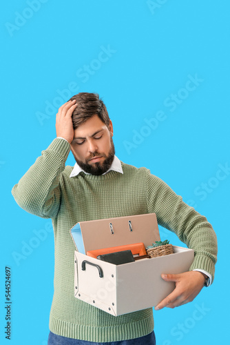 Sad fired young man holding...
