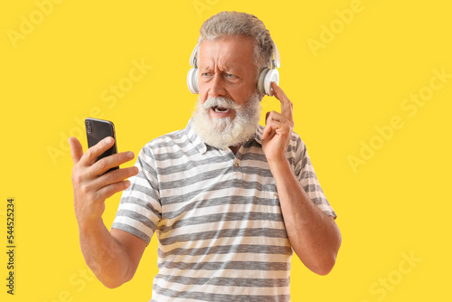 Displeased senior bearded m...