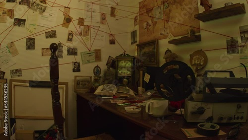 Tracking Shot Right to Left of a Conspiracy Theorists Workspace With Artifacts