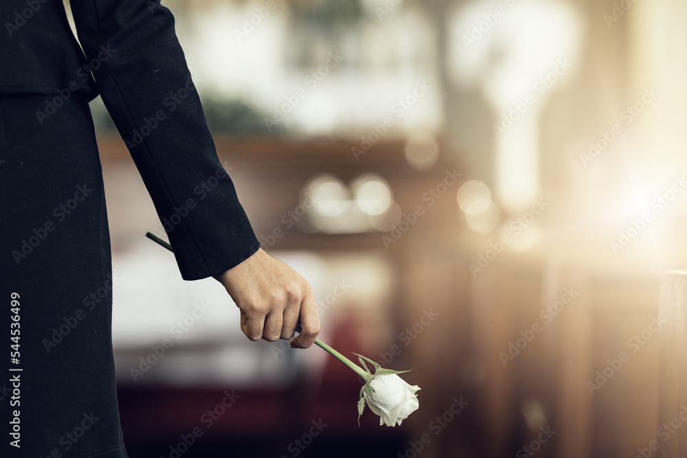 Flower, funeral and hand holding rose in mourning at death ceremony with grief for loss burial. Floral, church or cemetary with person holding plant for sad bereavement or cemetary event in a chapel - obrazy, fototapety, plakaty 