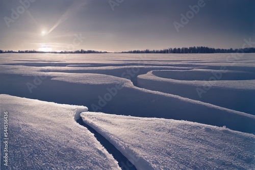 Winter landscape. Snowdrifts on the ice surface during sun.