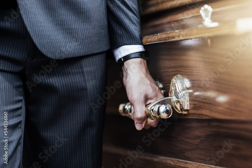 Funeral, man hands and holding coffin at a sad, death and church even of a person with casket. Support, loss and dead burial of a male at a religion, respect and mourning ceremony with a suit photo