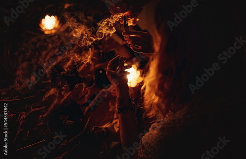 incense in a woman hand, ceremony space.