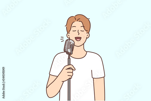 Smiling man sing in microphone 