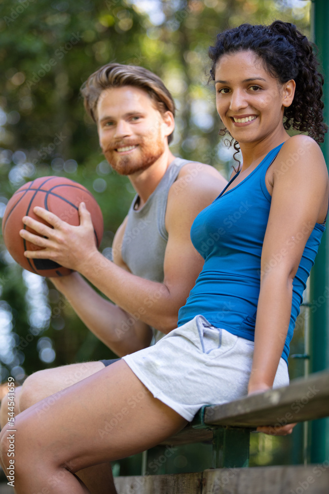 couple having a rest after playing sports outdoors