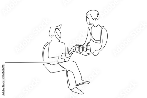 stewardess offering drink to female passenger