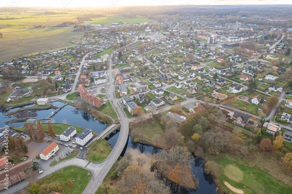 Aerial panoramic view on a little village in Europe, Sweden. Many private houses. Beautiful autumn sunlight, sunset. 