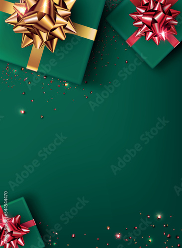 festive green background in flat lay style.A gift box wrapped in green paper, decorated with a gold and red bow and shiny confetti, lies on the surface, top view.Use for new year, christmas, birthday 