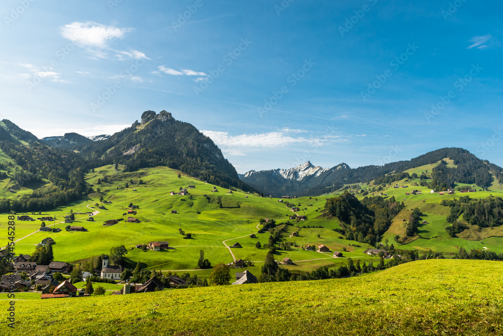 Landscape in Toggenburg with green meadows,  pastures and scattered farm houses near Nesslau, Canton St. Gallen, Switzerland