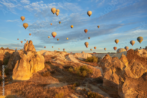 Fotografie, Obraz Hot air balloons flying in sunset sky Cappadocia, Goreme, Turkey