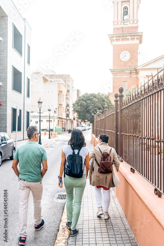 Group of friends walking down the street at city