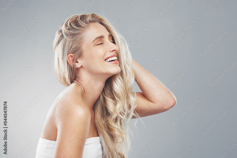 Hair care, woman and smile being happy, head and confident being content, proud and with grey studio background. Young female, girl or touch hair for wellness, natural beauty or happiness being bare