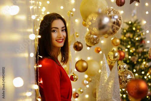 Portrait of woman in red suit in christmas decorations