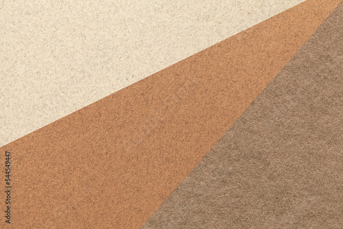Texture of old craft beige, brown and umber color paper background, macro. Structure of vintage abstract cardboard