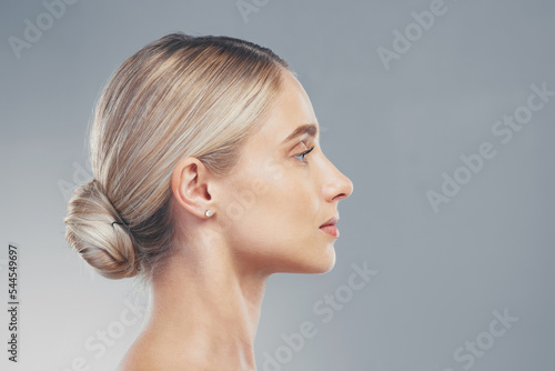 Skincare, profile and side face of a woman for dermatology, wellness and natural beauty against a grey mockup studio background. Advertising, marketing and model with cosmetic health and space
