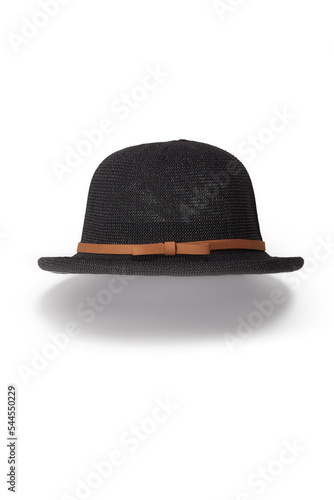 Close-up shot of a women's black woven bowler hat with a brown ribbon and a bow. The curved-brim woven summer hat is isolated on a white background. Front view.
