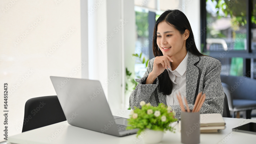 Asian businesswoman hands on chin, thinking new ideas for her project, working in the office. Asian businesswoman hands on chin, thinking new ideas for her project, working in the office.