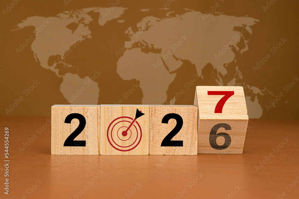 Countdown and business planning in 2027. Wooden cubes with the letters 2027 on a table with the world map background - obrazy, fototapety, plakaty 