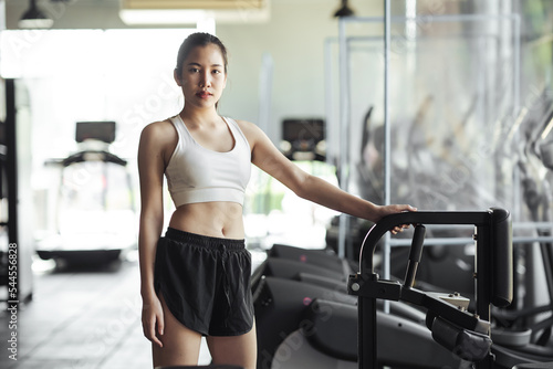 Portrait Asian woman in sportswear at fitness gym. Healthcare and healthy lifestyle concept.