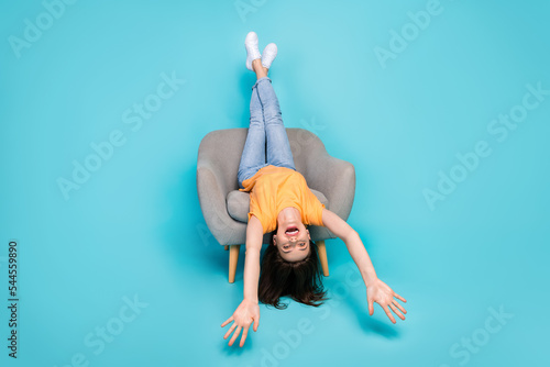 Full length photo of overjoyed crazy lady sitting lying cozy chair have fun enjoy free time good mood isolated on blue color background #544559890