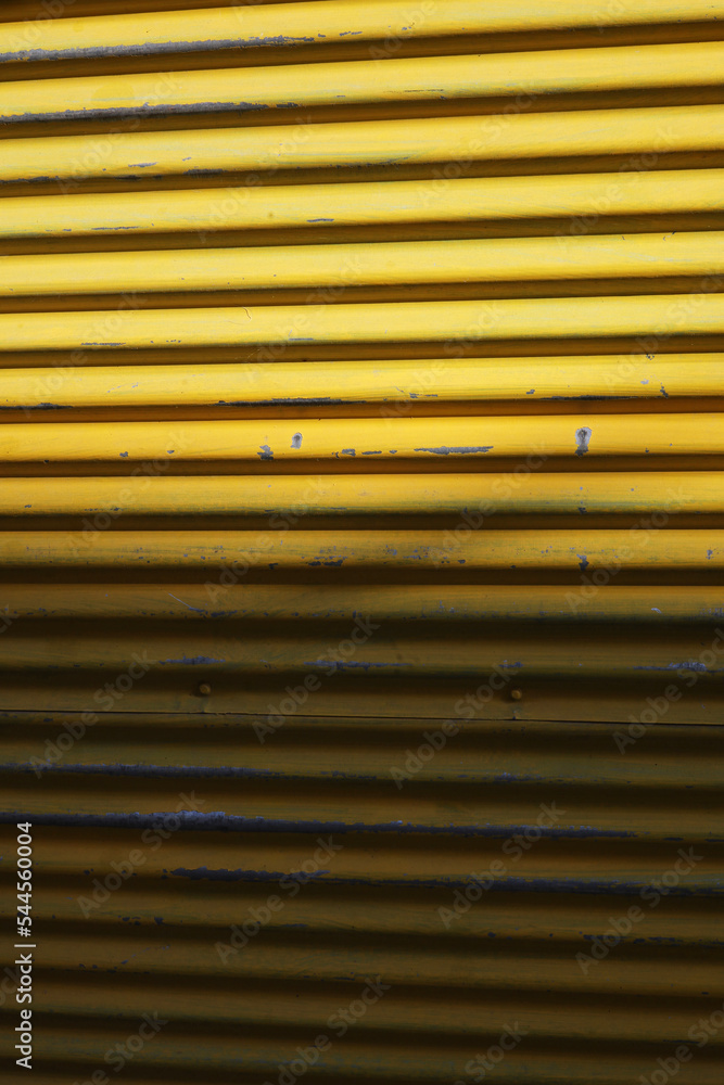 Fototapeta premium yellow metal shutter background with stripes